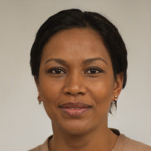 Joyful black adult female with short  black hair and brown eyes