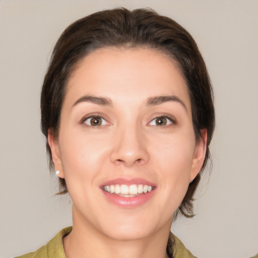 Joyful white young-adult female with medium  brown hair and brown eyes