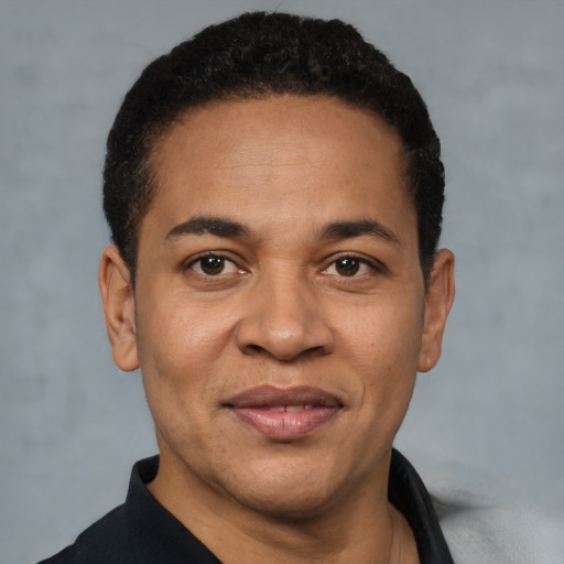 Joyful latino adult male with short  brown hair and brown eyes