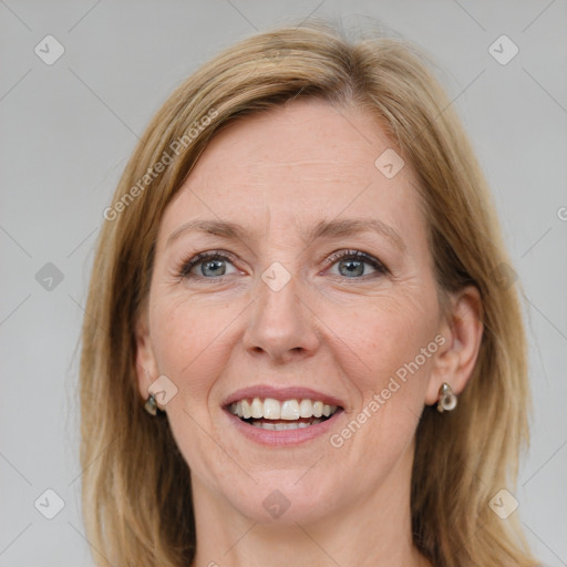 Joyful white adult female with medium  brown hair and blue eyes