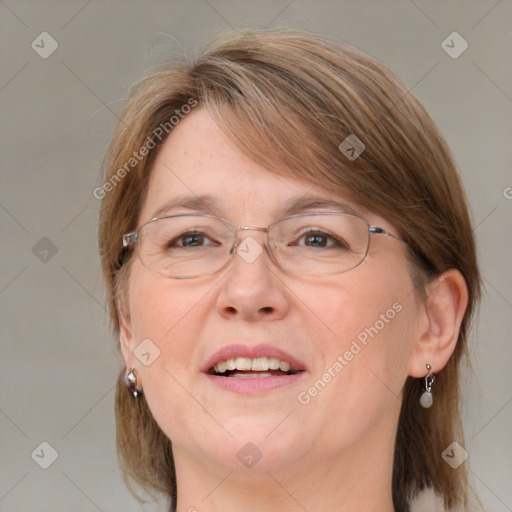 Joyful white adult female with medium  brown hair and blue eyes