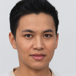 Joyful asian young-adult male with short  brown hair and brown eyes