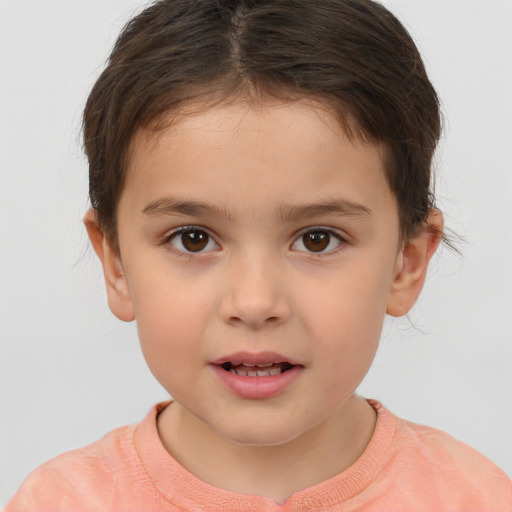 Joyful white child female with short  brown hair and brown eyes