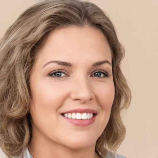 Joyful white young-adult female with medium  brown hair and green eyes