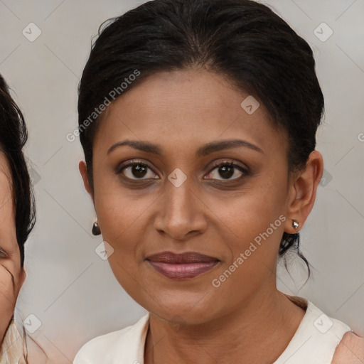 Joyful black young-adult female with medium  brown hair and brown eyes