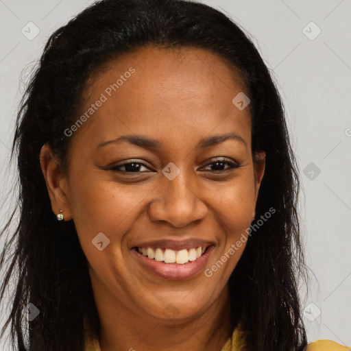 Joyful black young-adult female with long  brown hair and brown eyes