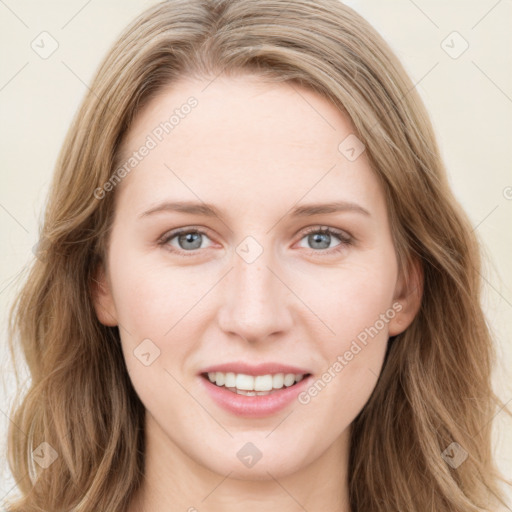 Joyful white young-adult female with long  brown hair and blue eyes