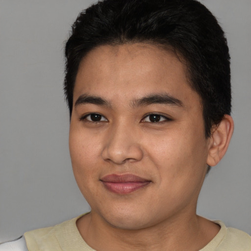 Joyful latino young-adult male with short  brown hair and brown eyes