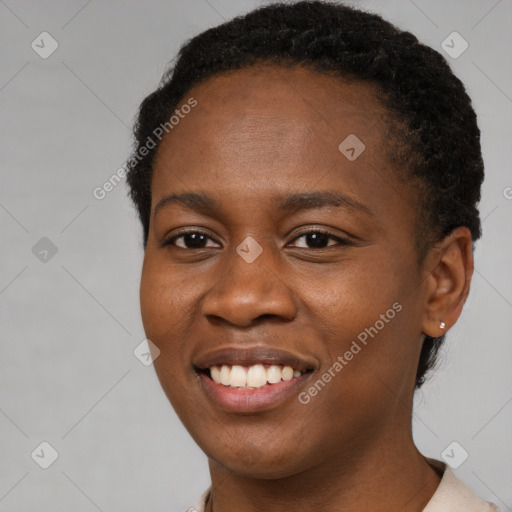 Joyful black young-adult female with short  brown hair and brown eyes