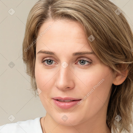 Joyful white young-adult female with medium  brown hair and green eyes