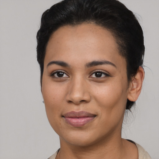 Joyful latino young-adult female with short  black hair and brown eyes