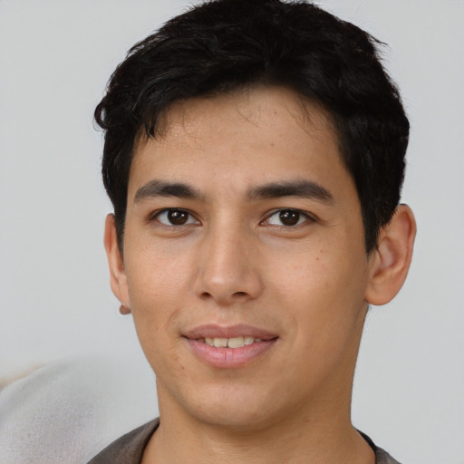 Joyful asian young-adult male with short  black hair and brown eyes