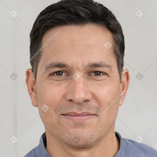 Joyful white adult male with short  brown hair and brown eyes