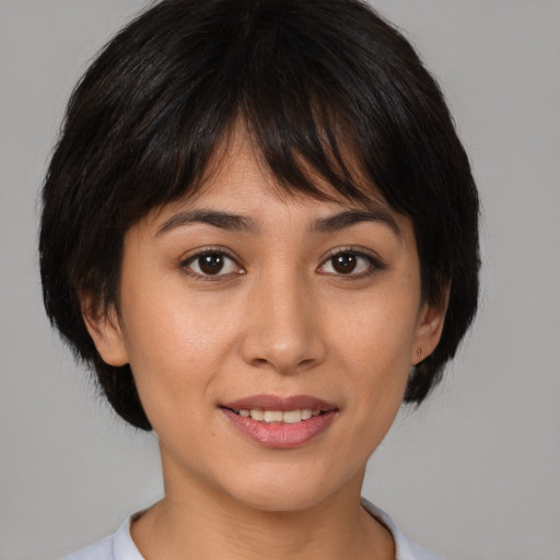 Joyful asian young-adult female with medium  brown hair and brown eyes