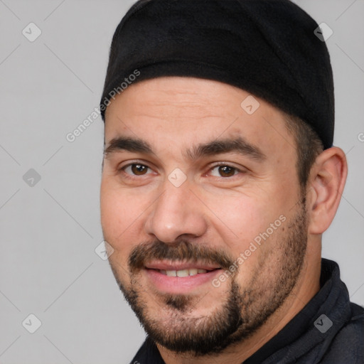 Joyful white adult male with short  black hair and brown eyes