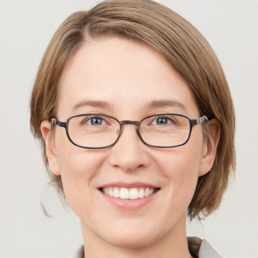 Joyful white young-adult female with medium  brown hair and green eyes