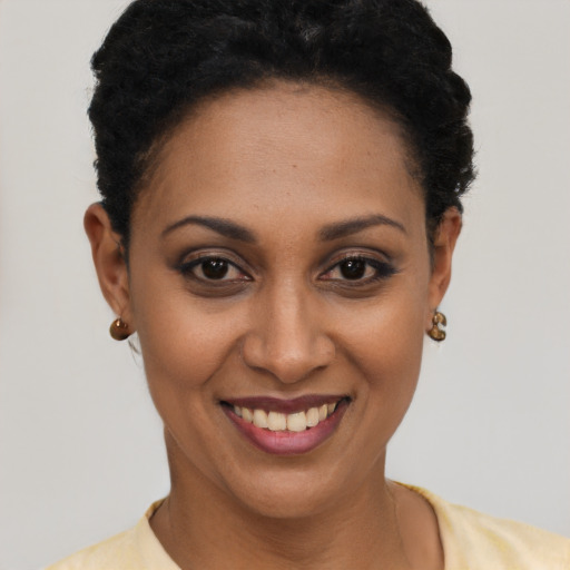 Joyful latino young-adult female with short  brown hair and brown eyes