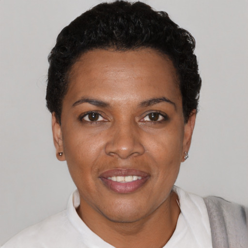 Joyful black young-adult female with short  black hair and brown eyes