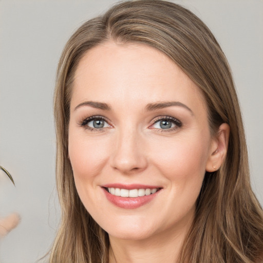 Joyful white young-adult female with long  brown hair and grey eyes