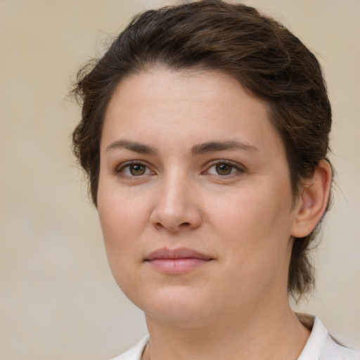 Joyful white young-adult female with medium  brown hair and green eyes