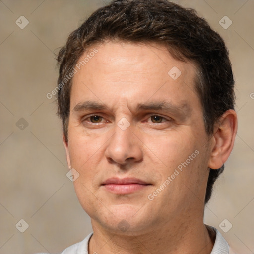 Joyful white adult male with short  brown hair and brown eyes