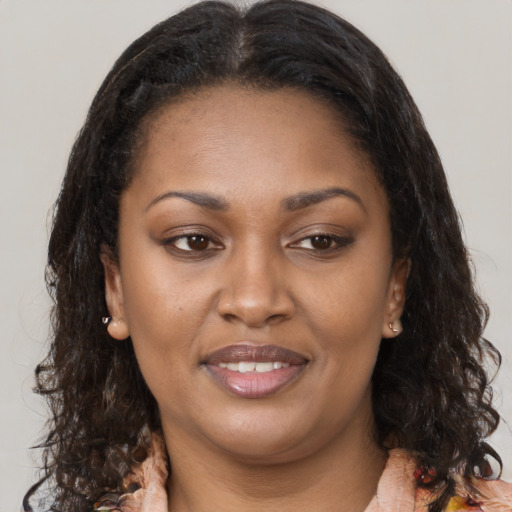 Joyful black young-adult female with medium  brown hair and brown eyes