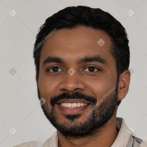 Joyful latino young-adult male with short  black hair and brown eyes