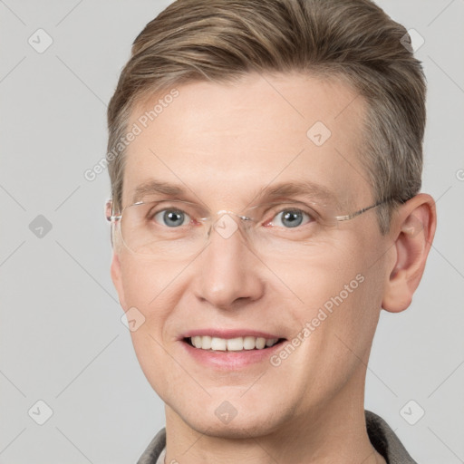 Joyful white adult male with short  brown hair and grey eyes