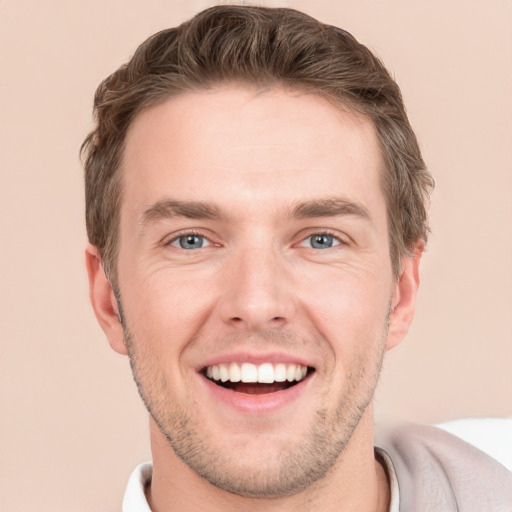 Joyful white young-adult male with short  brown hair and grey eyes