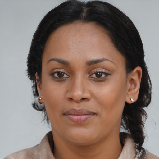 Joyful black young-adult female with long  brown hair and brown eyes