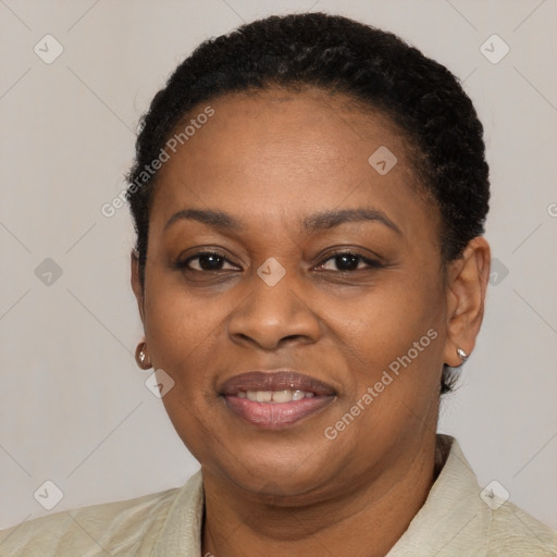 Joyful black adult female with short  brown hair and brown eyes