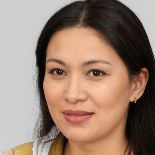 Joyful latino adult female with long  brown hair and brown eyes