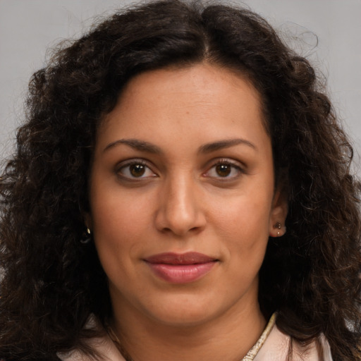 Joyful latino young-adult female with long  brown hair and brown eyes