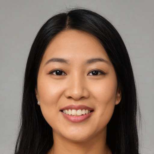Joyful latino young-adult female with long  black hair and brown eyes