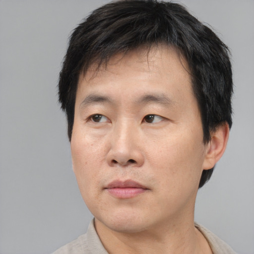 Neutral asian adult male with short  brown hair and brown eyes