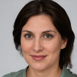 Joyful white adult female with medium  brown hair and brown eyes