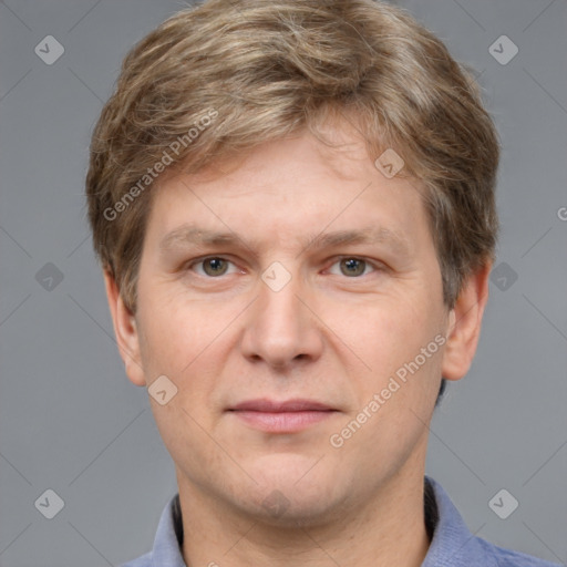 Joyful white adult male with short  brown hair and grey eyes