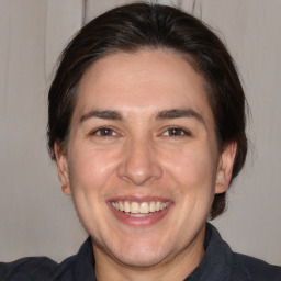 Joyful white adult male with medium  brown hair and brown eyes