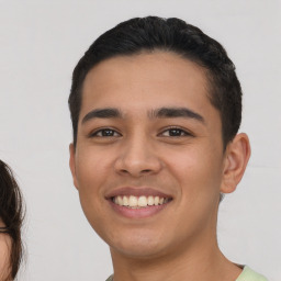 Joyful latino young-adult male with short  brown hair and brown eyes