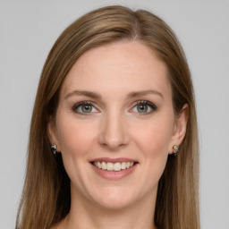 Joyful white young-adult female with long  brown hair and grey eyes