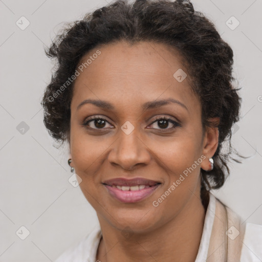 Joyful black adult female with medium  brown hair and brown eyes