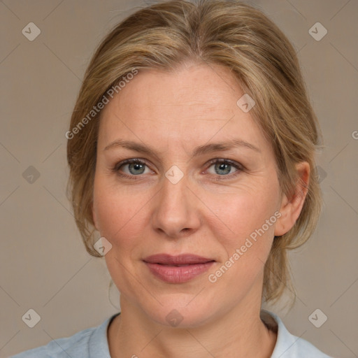 Joyful white adult female with medium  brown hair and blue eyes