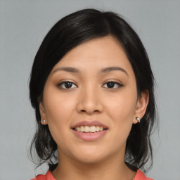 Joyful asian young-adult female with medium  black hair and brown eyes