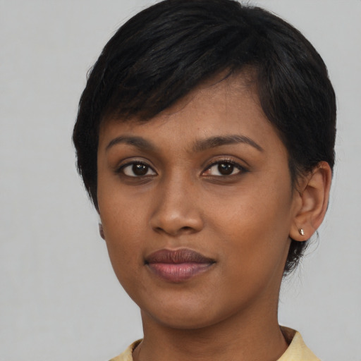 Joyful black young-adult female with medium  black hair and brown eyes