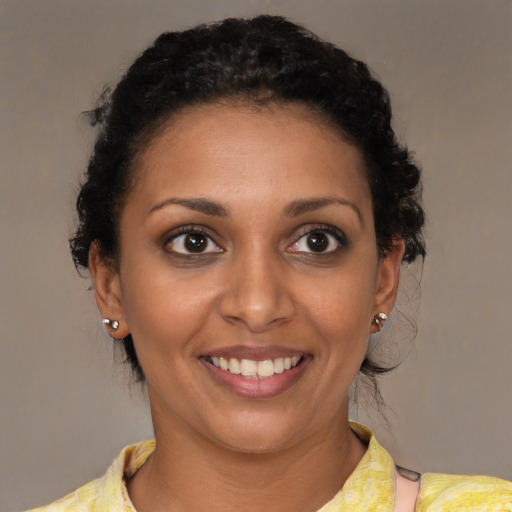 Joyful black young-adult female with short  brown hair and brown eyes