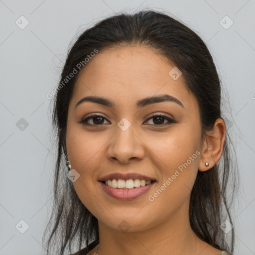 Joyful latino young-adult female with long  brown hair and brown eyes