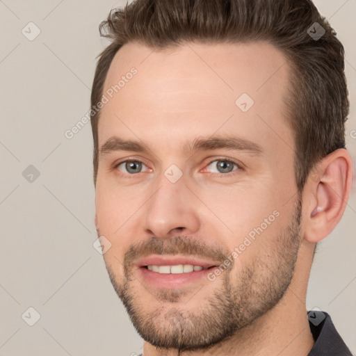 Joyful white young-adult male with short  brown hair and brown eyes