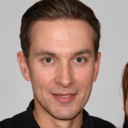 Joyful white adult male with short  brown hair and brown eyes