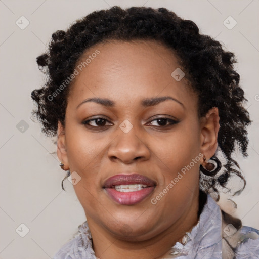 Joyful black adult female with medium  brown hair and brown eyes