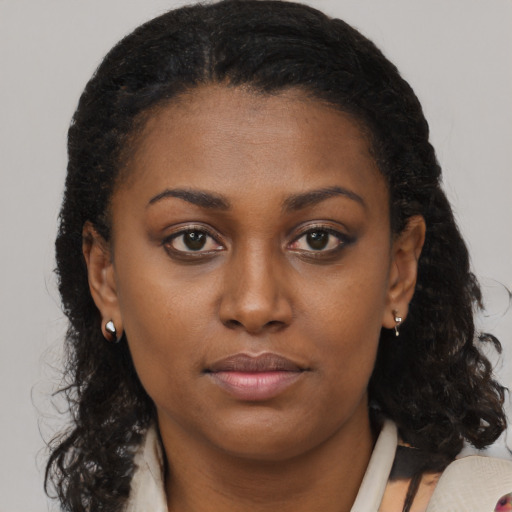 Neutral black young-adult female with medium  brown hair and brown eyes